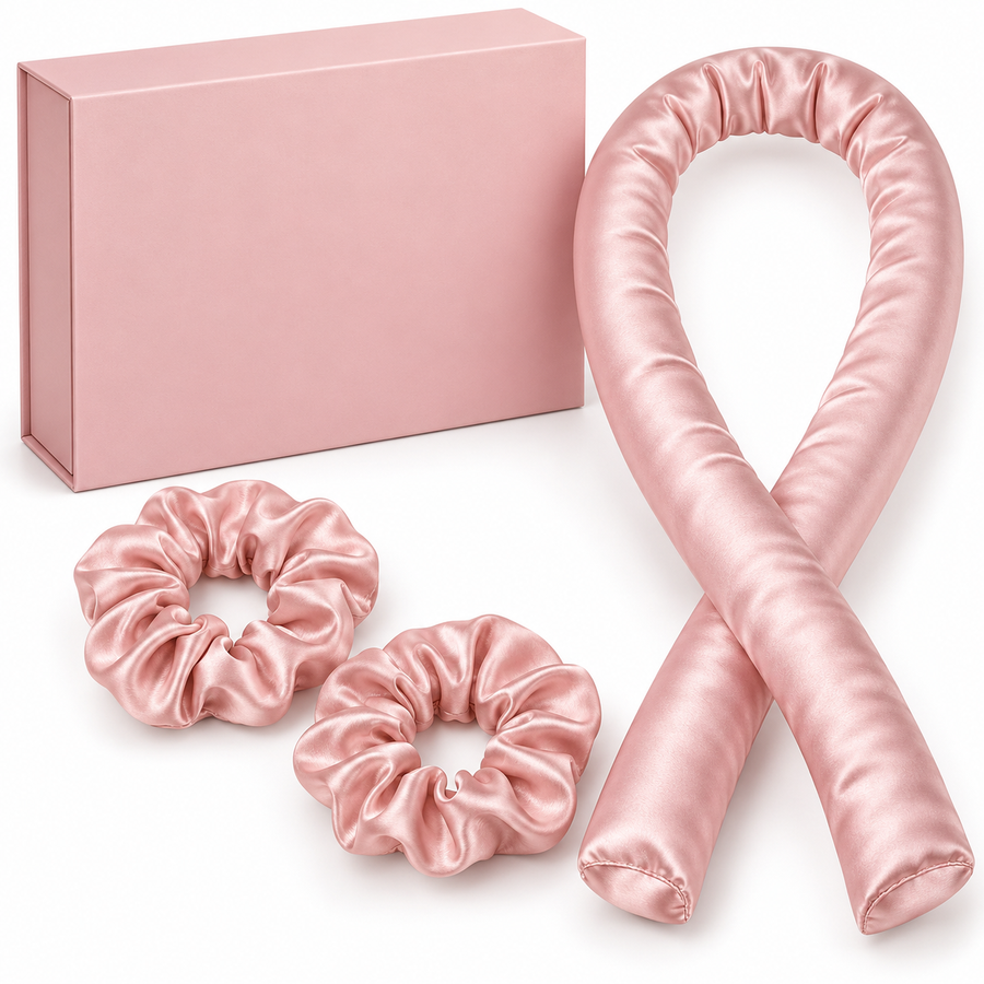 Pink curling ribbon, two scrunchies and unbranded gift box on white
